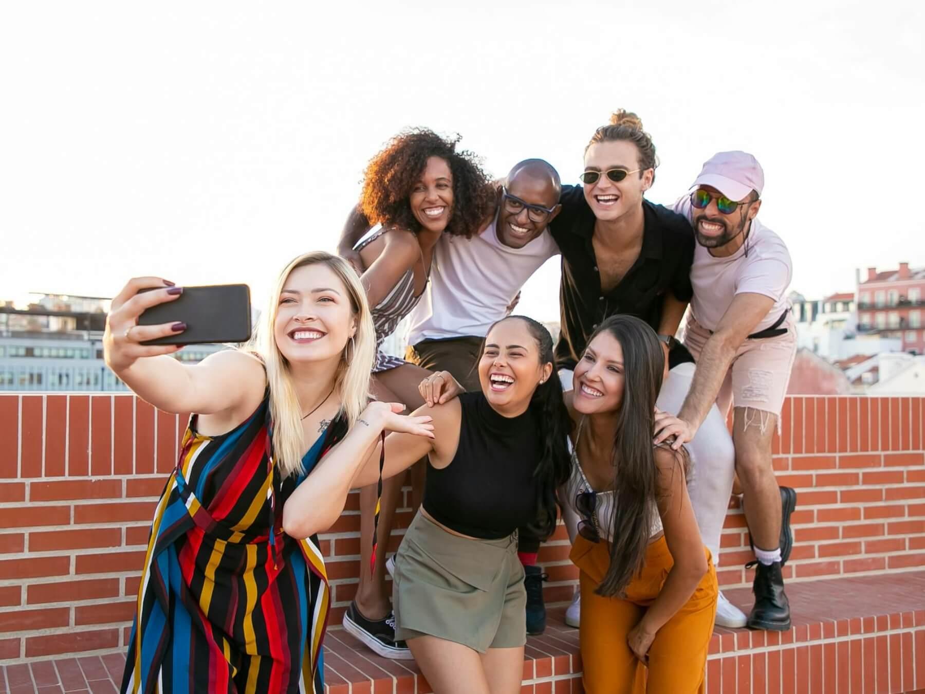 Group of young, diverse people taking a selfie