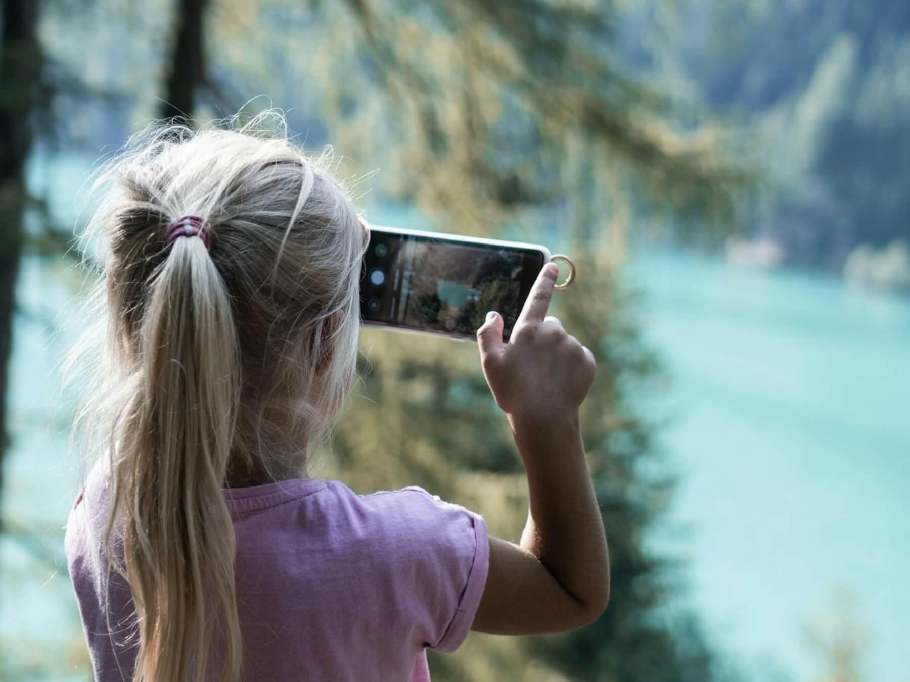 Child taking a photo using a smartphone