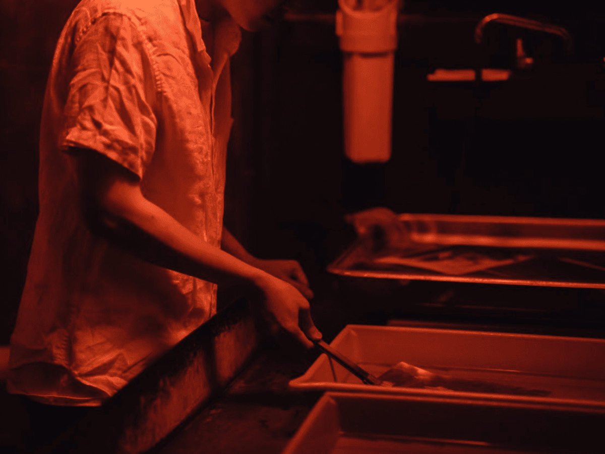 Man Developing Pictures in a Darkroom.