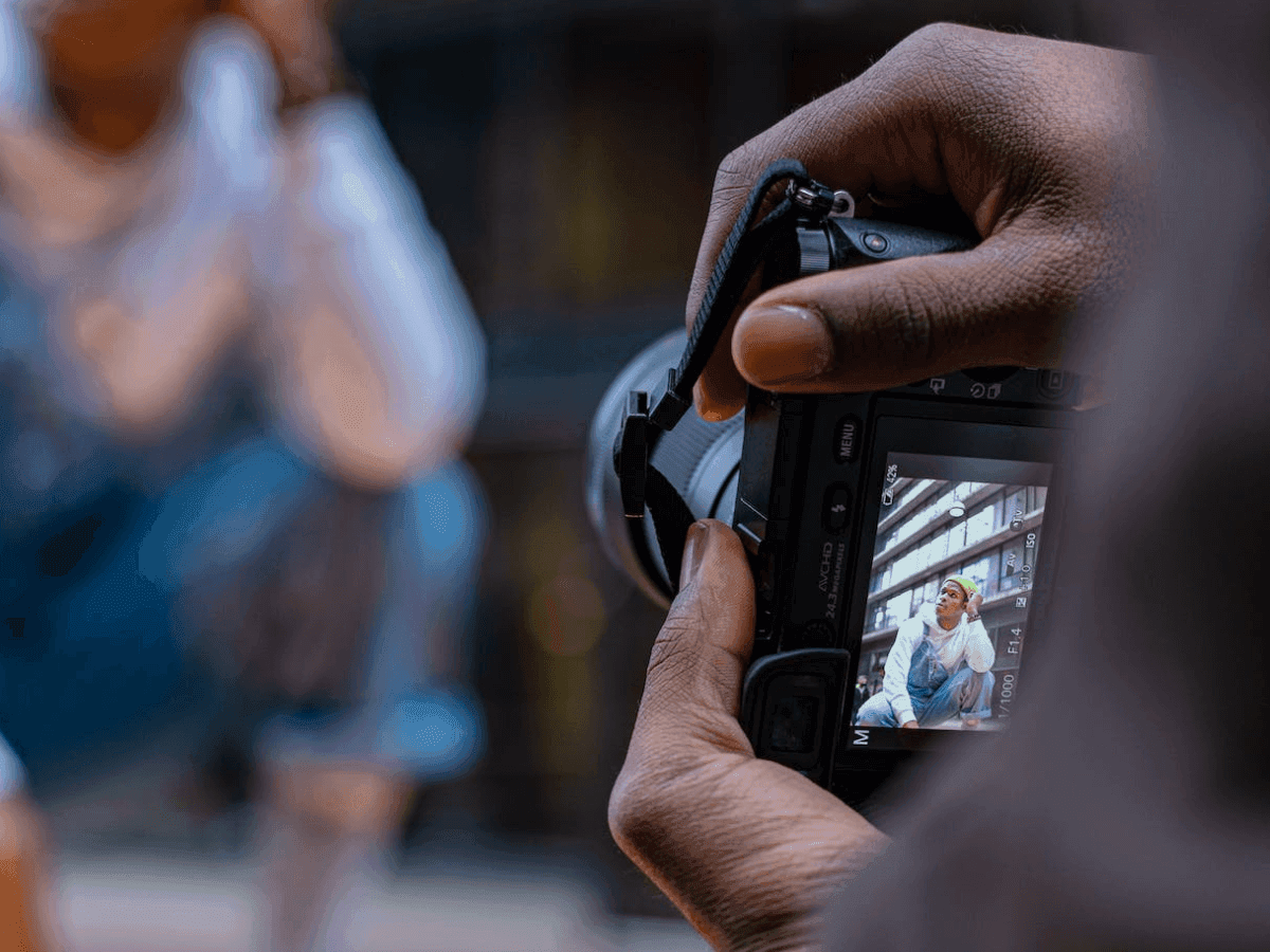 Person Taking Photo on Professional Camera Outdoors